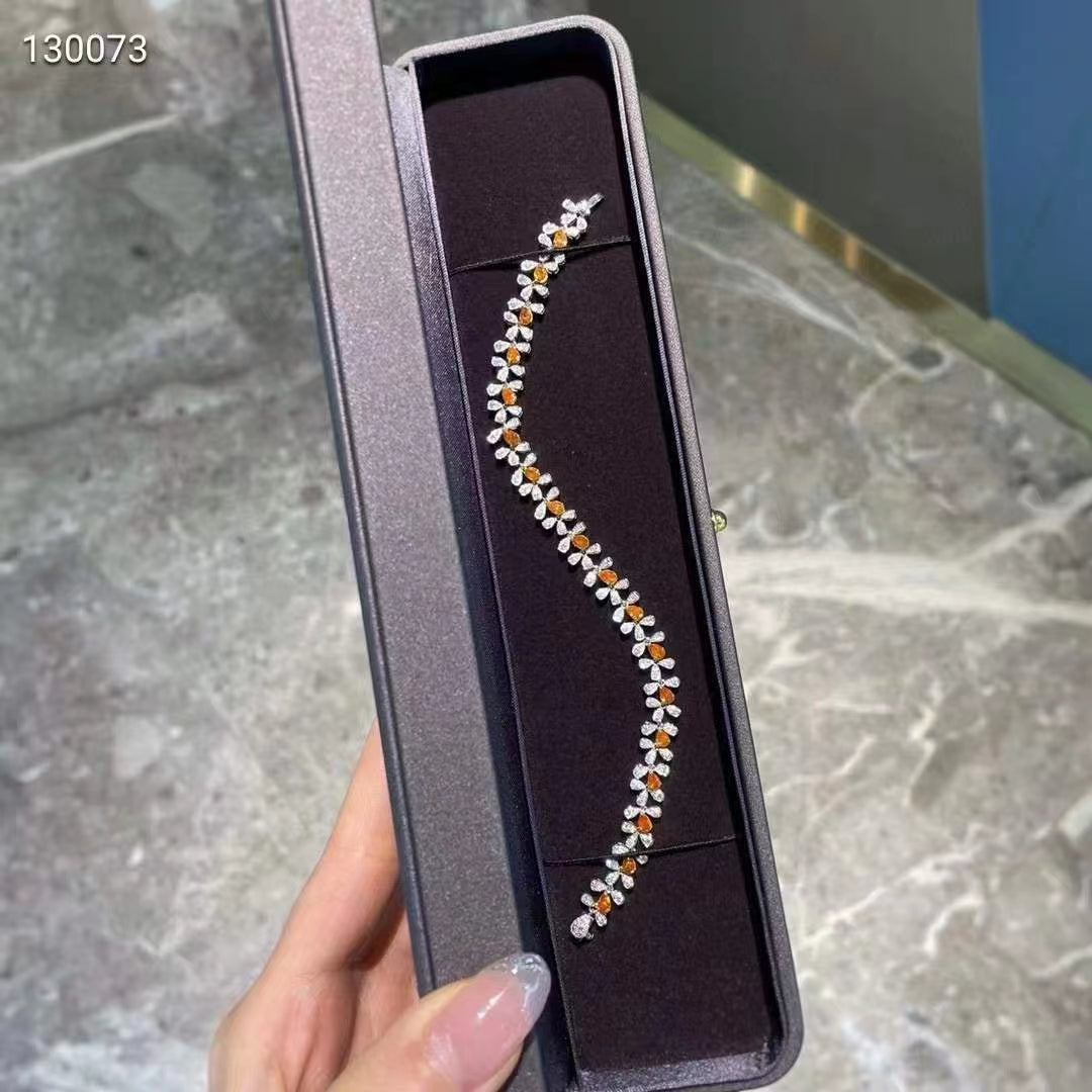 A gem of elegance: 18k white gold bracelet with orange diamonds